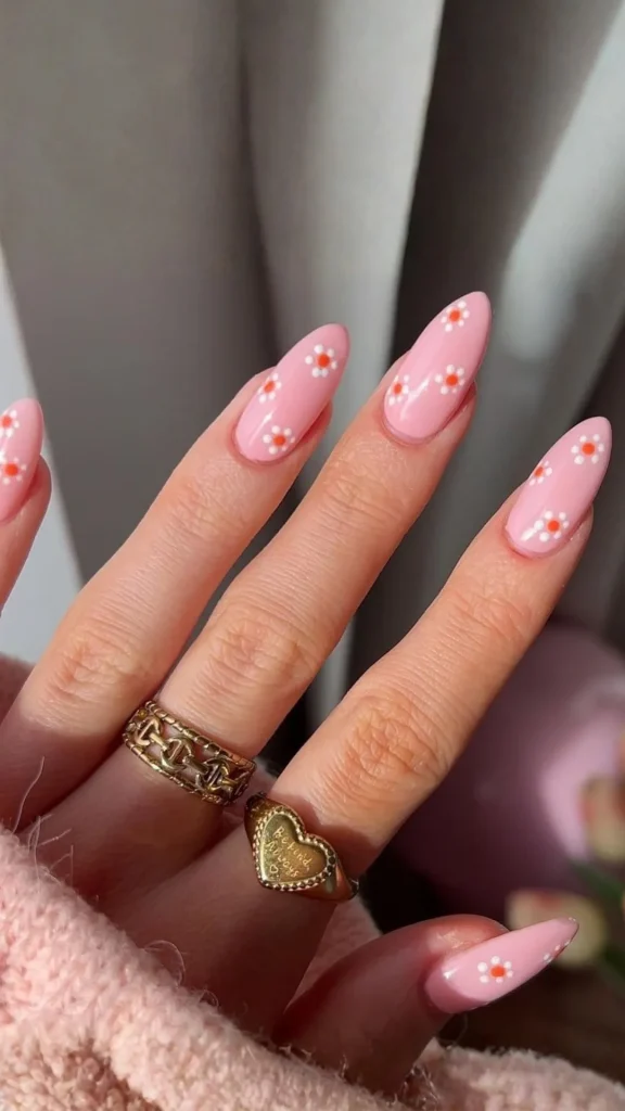 Pink and white floral French tip spring nails on almond shape manicure