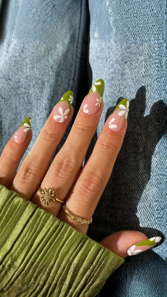 Gradient pastel spring nails with tiny white flowers on each ombré nail