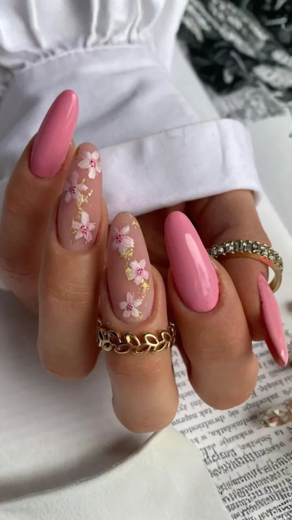 Neon pink daisy spring nails with bold flowers on short rounded manicure