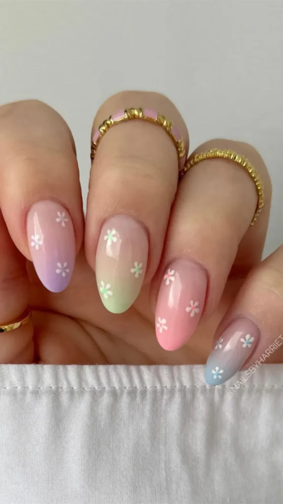 Short pastel French tip spring nails with tiny floral and skittle colors