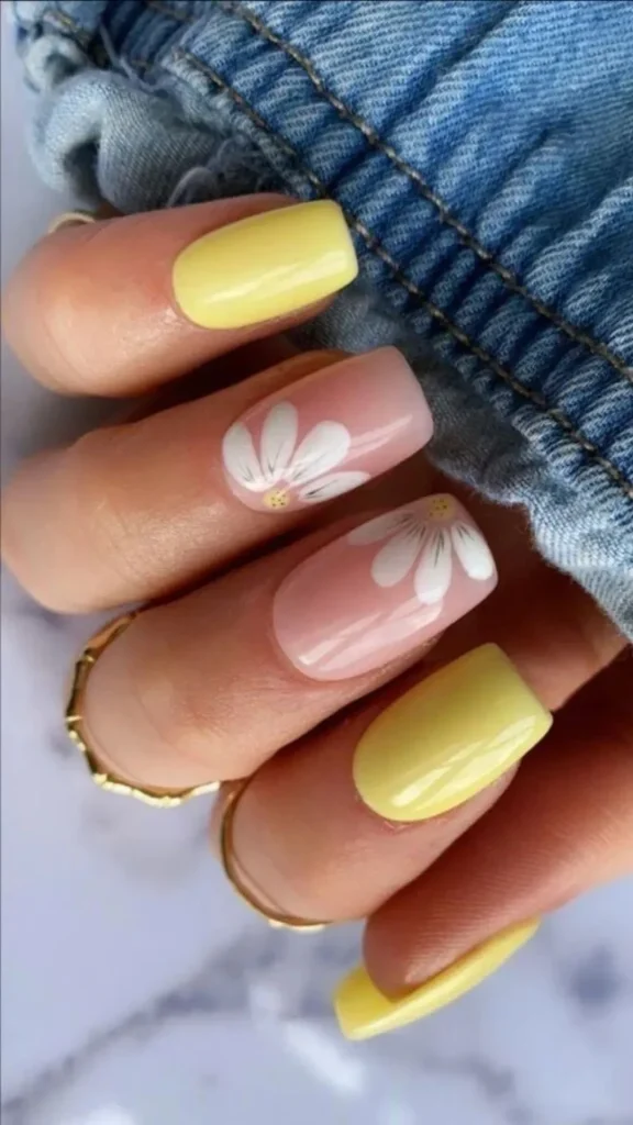 Colorful confetti floral spring nails with teal and pink accents on almond shape