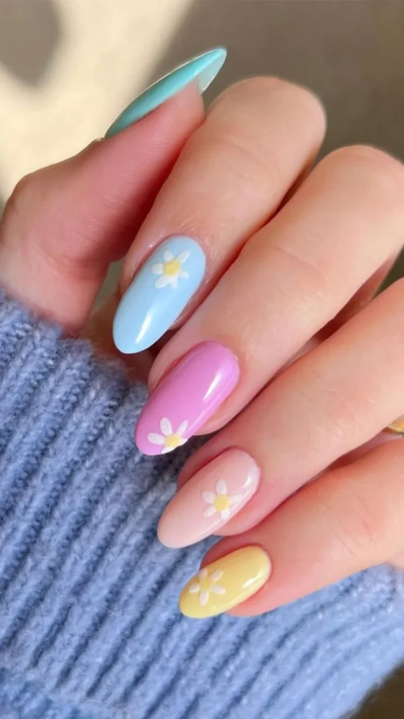 Pastel rainbow daisy French tip spring nails with nude base and tiny white flowers