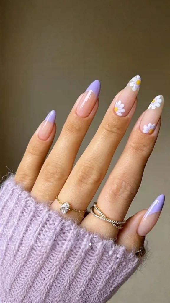 Pastel skittle spring nails with tiny white flowers on each ombré nail