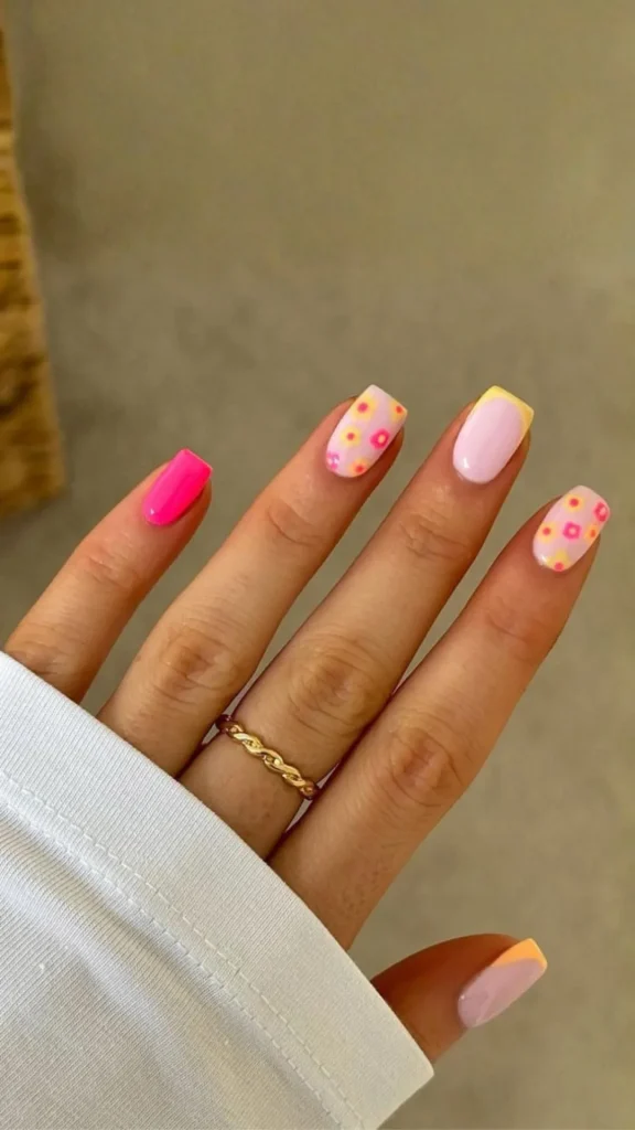 Colorful floral spring nails with turquoise and pink petals on nude base